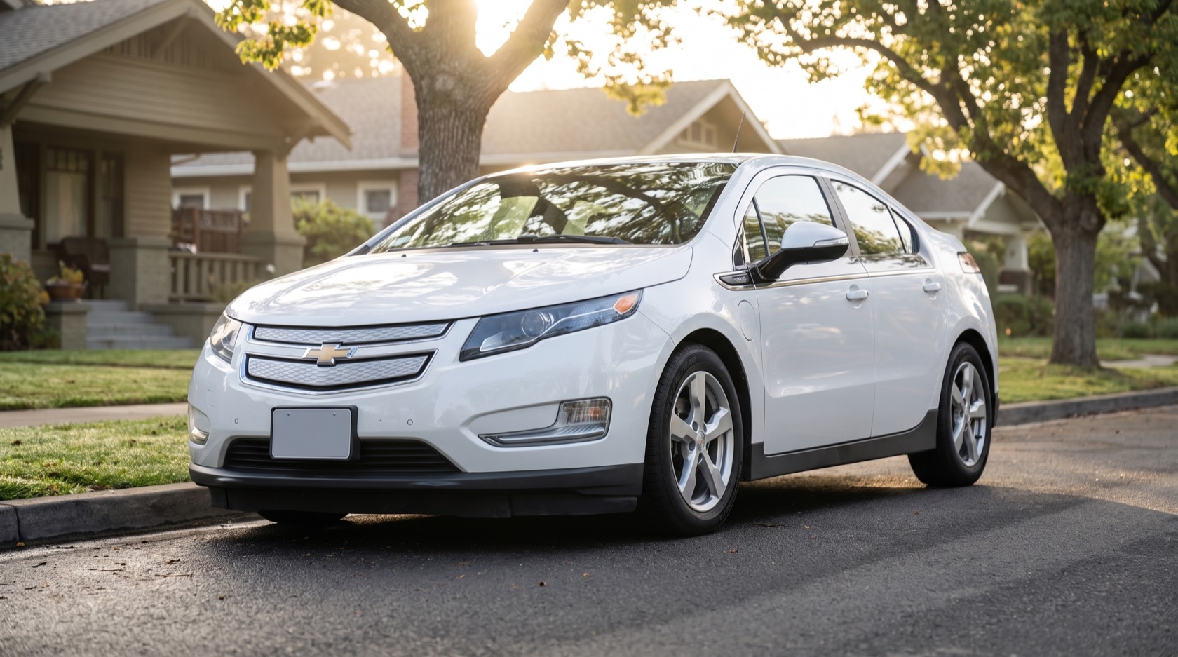 Volt, a white 2014 Chevrolet Volt, parked on a tree-lined residential street in morning light